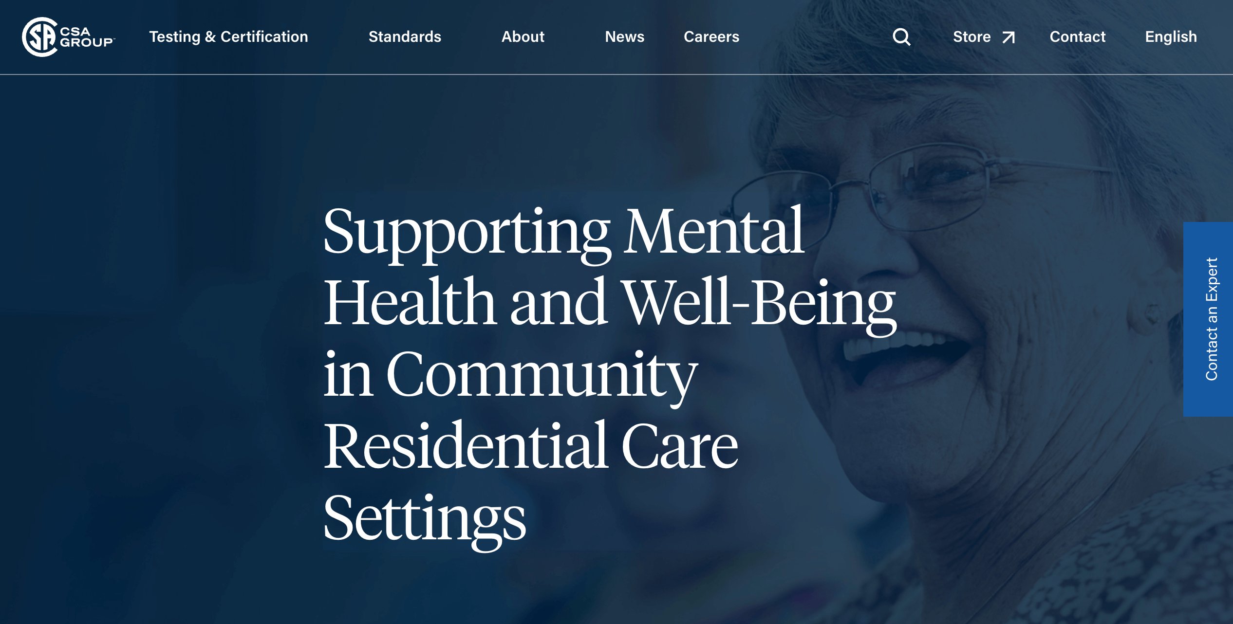 Screen captur image of the CSA Group website homepage which is predominantly dark blue with a transparent image of a happy and smiling older adult woman.